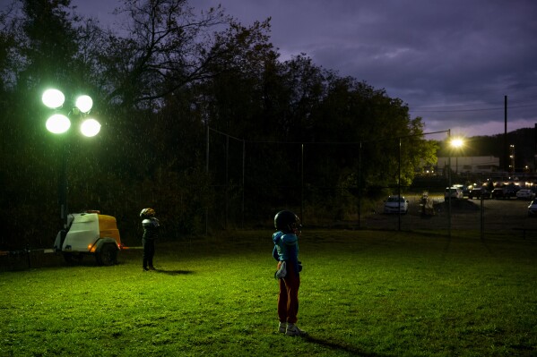 Youth football players stand in the rain at practice across the street from the Clairton Coke Works in Clairton, Pa., on Thursday, Oct. 23, 2025. (Quinn Glabicki/Pittsburgh's Public Source via AP)