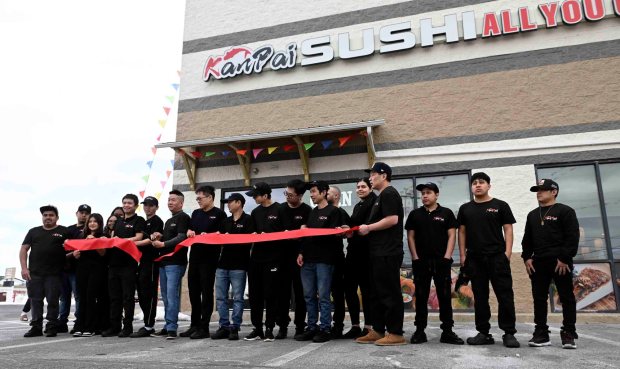 Jie "Neil" Weng, general manager, cuts the ribbon with staff at the grand opening of Kanpai Sushi, 3407 Fifth Street Highway, Muhlenberg Township, on Thursday, Feb. 12, 2026. (BILL UHRICH/MEDIANEWS GROUP)