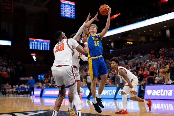 Pittsburgh guard Nojus Indrusaitis (25) drives to the basket against Virginia center Ugonna Onyenso (33) during the first half of an NCAA college basketball game, Tuesday, Feb. 3, 2026, in Charlottesville, Va. (AP Photo/Robert Simmons)