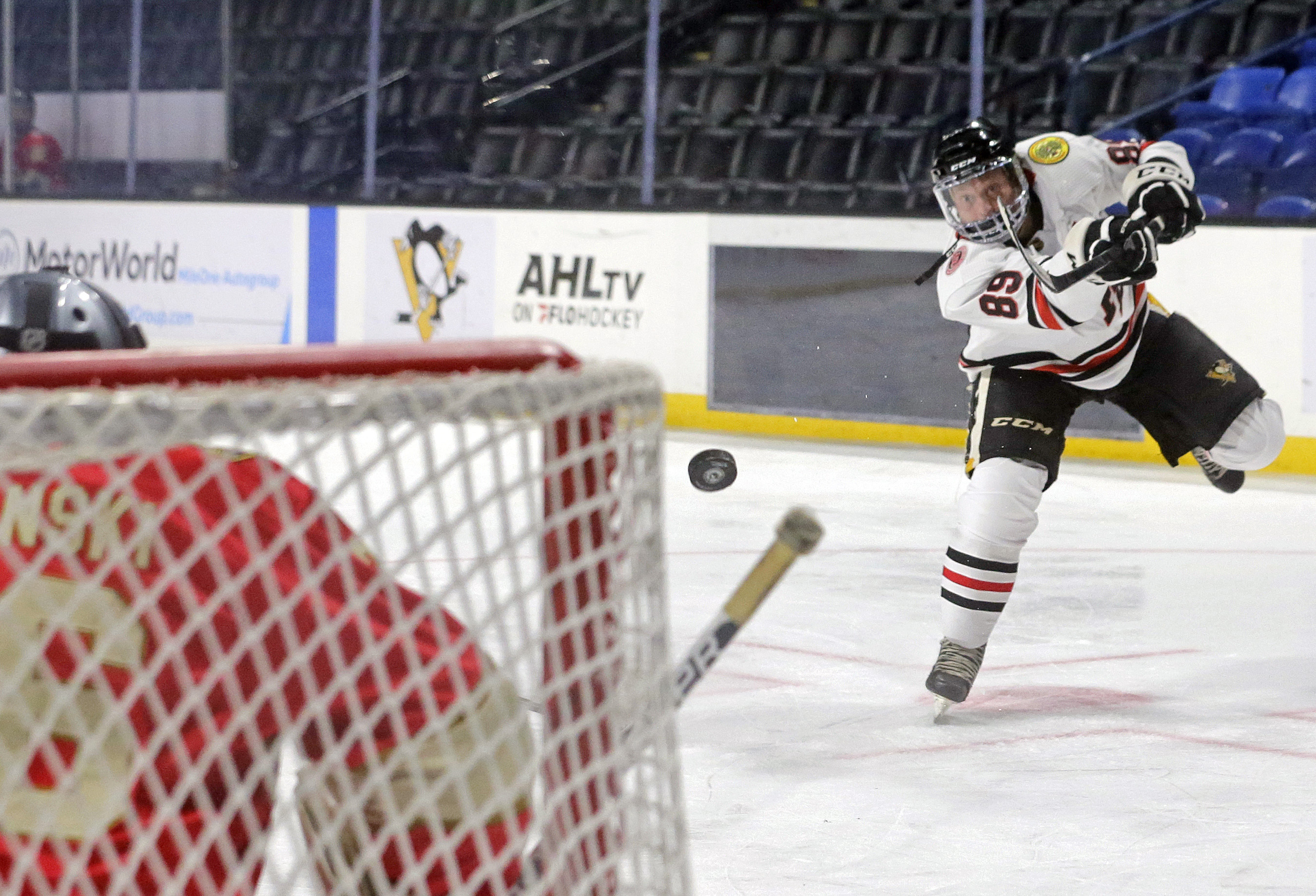 Scranton’s Jamie Zaleski shoots the puck against Wilkes-Barre goalkeeper Walter...