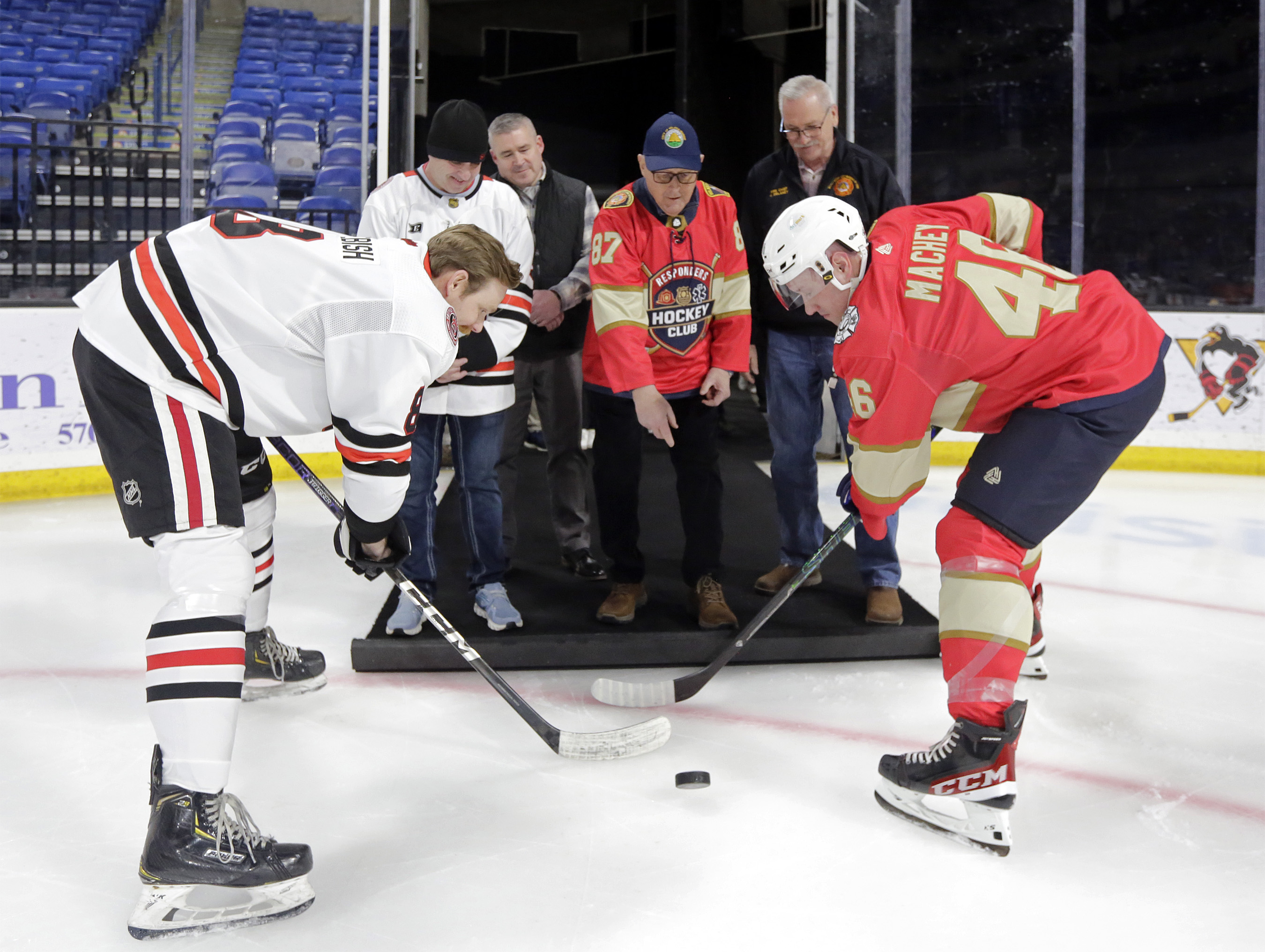 Wilkes-Barre Mayor George Brown, center, leads the ceremonial puck drop...