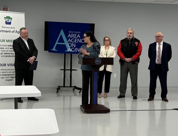 Lisa Rachmuth, program administrator of Weill Cornell Medicine's Center for Elder Abuse Solutions, applauds Pennsylvania Secretary of Aging Jason Kavulich during an event Tuesday at the Berks County Area Agency on Aging, (STEVEN HENSHAW - READING EAGLE)