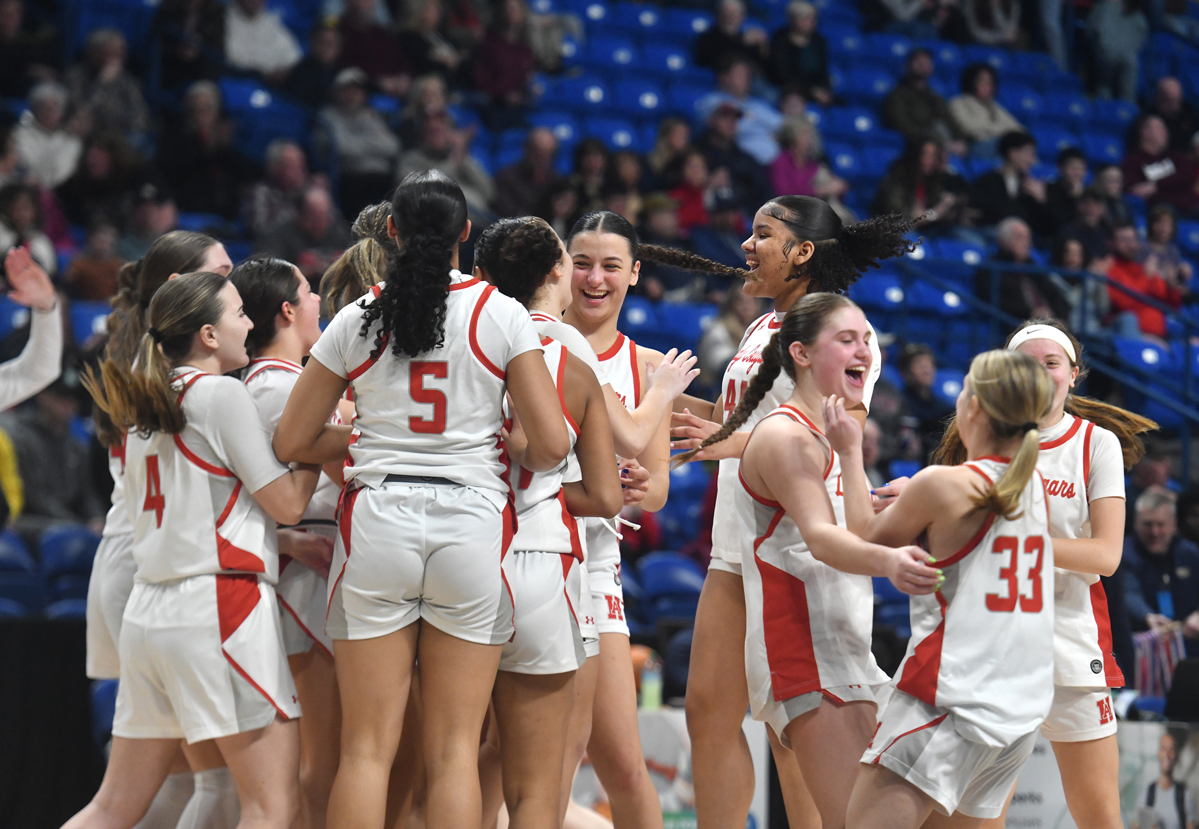 Hazleton Area players celebrate after defeating Scranton for the PIAA...
