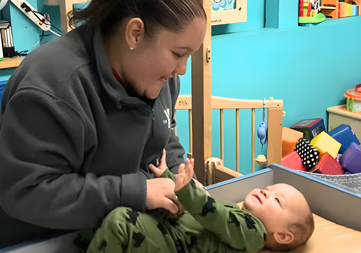 YMCA childcare staff caring for infant in Erie County