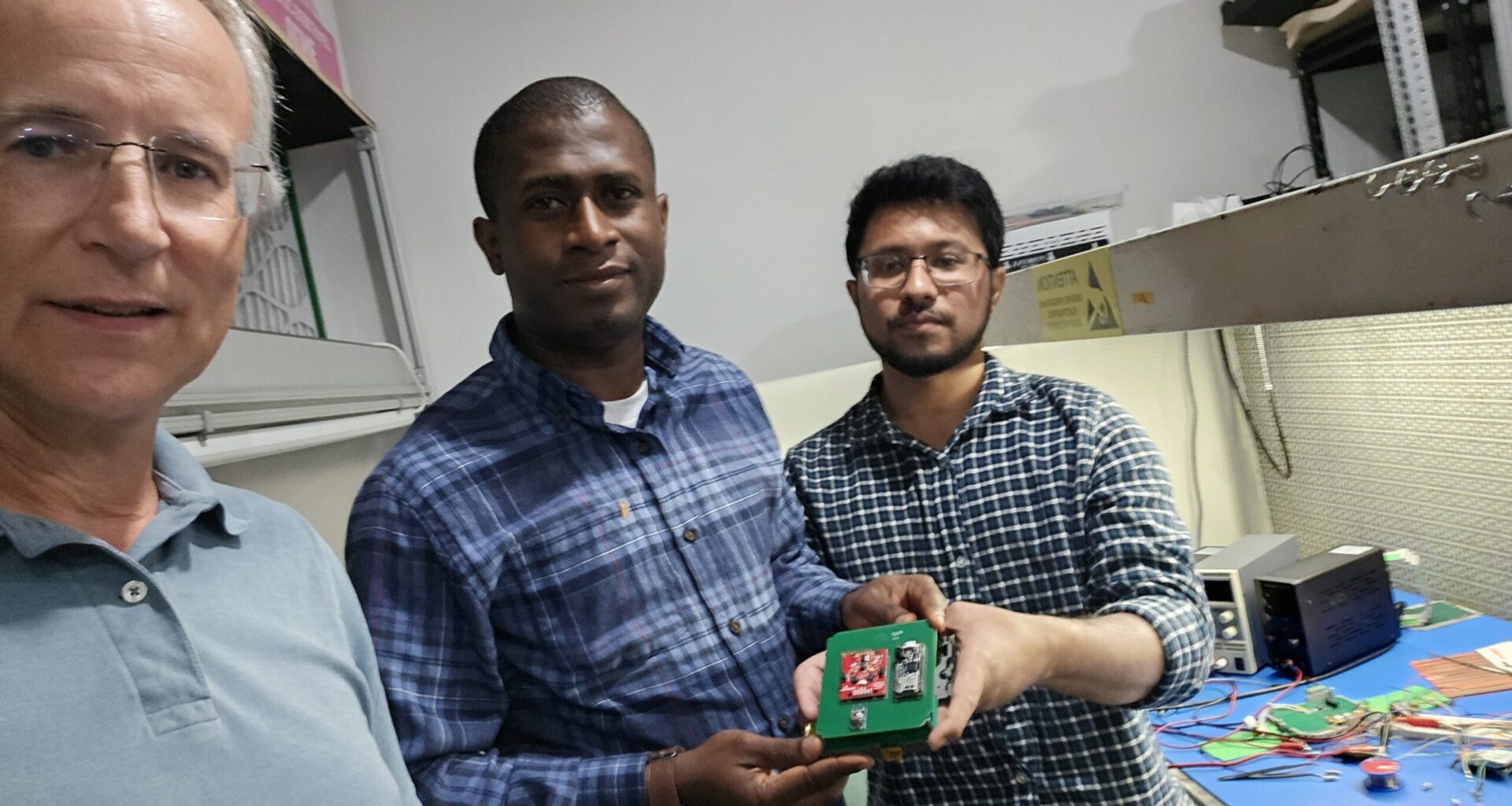 From left to right, Kevin Czajkowski, Olawale Oluwafemi, and Md. Faisal Karim displaying the STELLA-inspired sensor just after it had passed inspection at Near Space Launch.