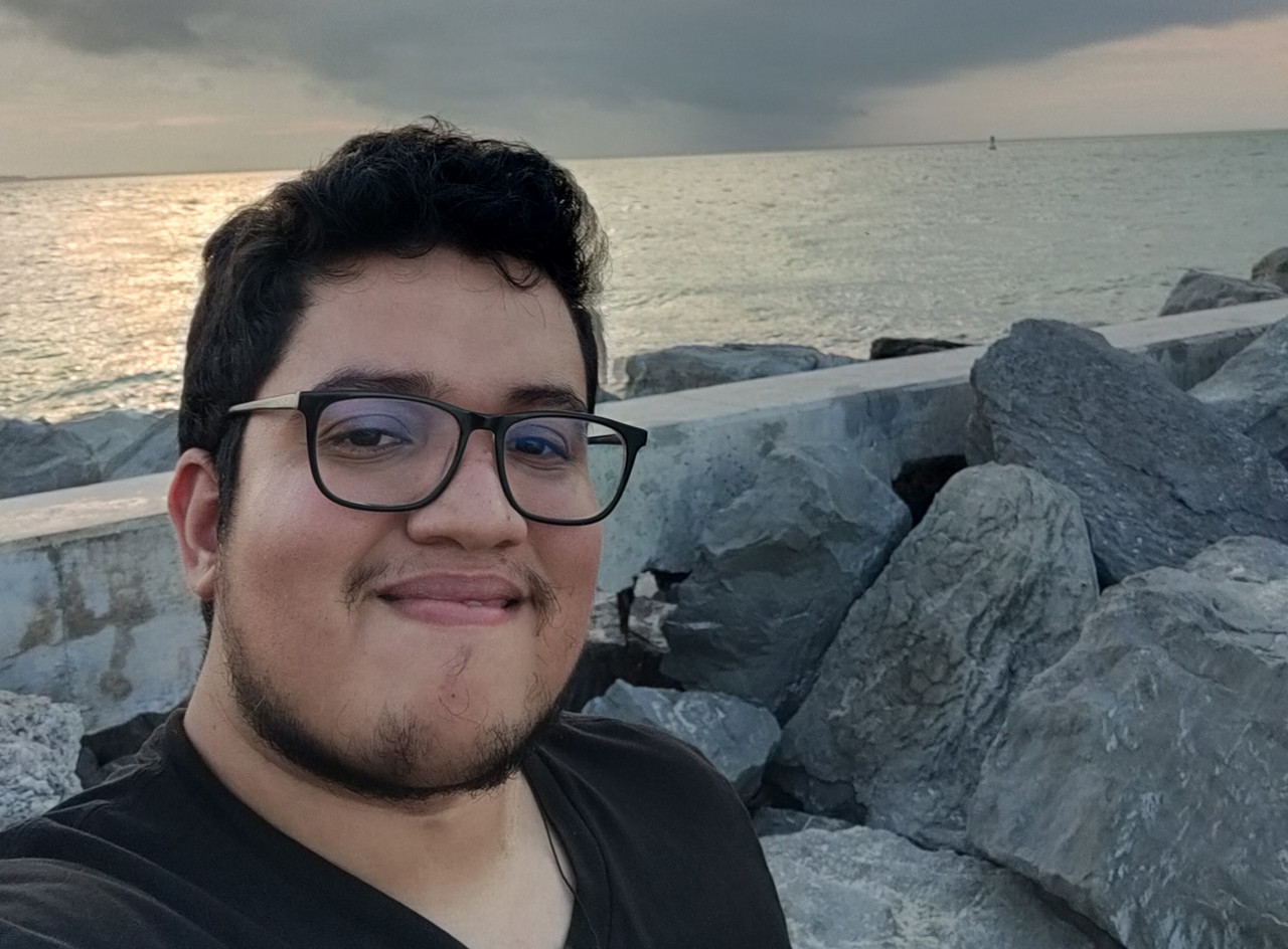 young male on rocky beach