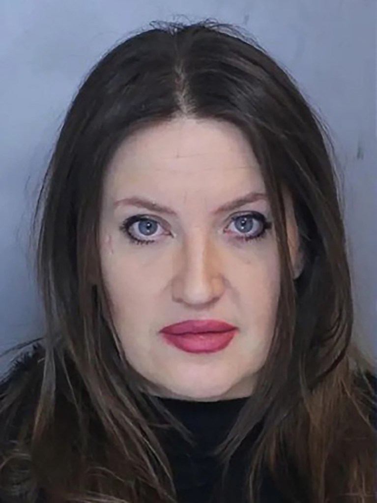 Mugshot of Brittany Ortiz with long dark hair, blue eyes, and pink lipstick.