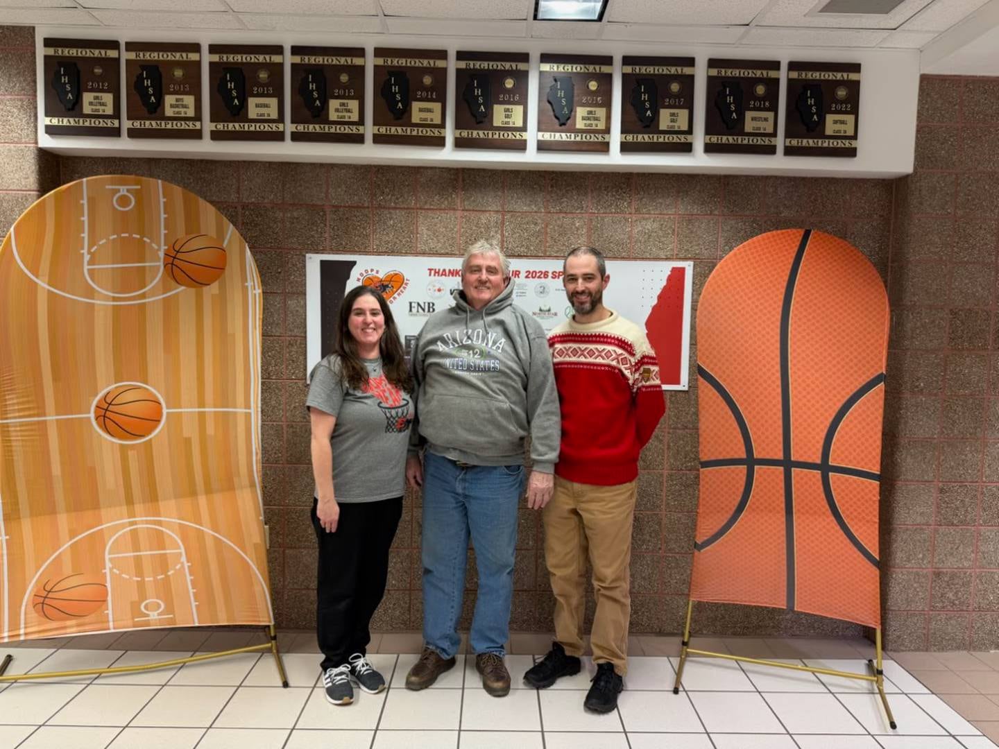 E-P team mom Jennifer Malone (left) came up with Hoops for Heart on behalf of her dad, Alan Ringenberg (center), and her late mom, Jill, who both experienced cardiac issues. Also pictured, is Jennifer’s brother, Greg.