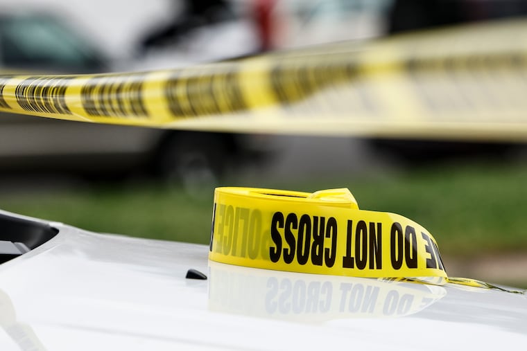 A file photo of police caution tape on the hood of a police vehicle in May 2024.