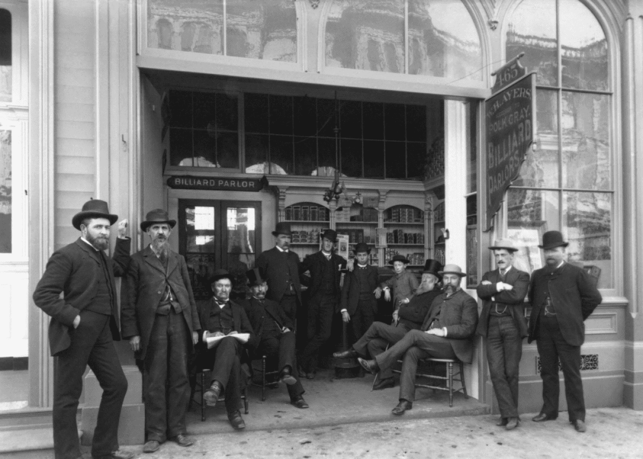 Group of men in front of a billiard parlor