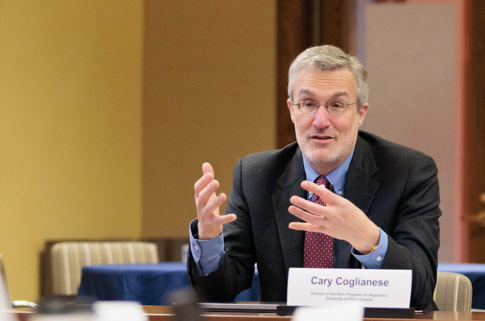 Professor Cary Coglianese seated at a table, speaking