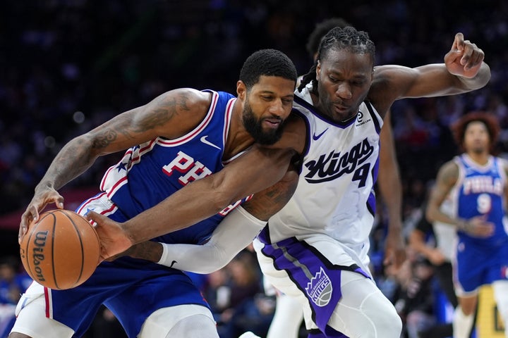 Philadelphia 76ers' Paul George, left, tries to get past Sacramento Kings' Precious Achiuwa during the second half of an NBA basketball game Thursday, Jan. 29, 2026, in Philadelphia. (AP Photo/Matt Slocum)