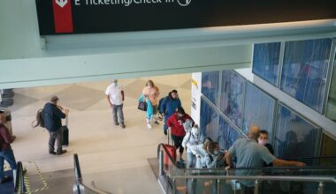 Passengers ride an escalator to Terminal E in the Philadelphia International Airport in this 2021 file photo.