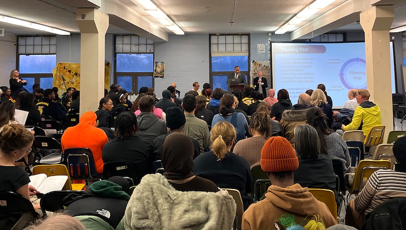 A crowd fills a big room.