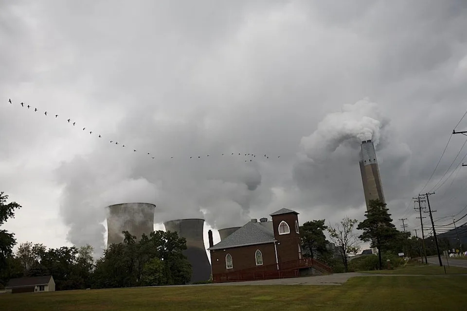 A power plant emits smoke and steam.