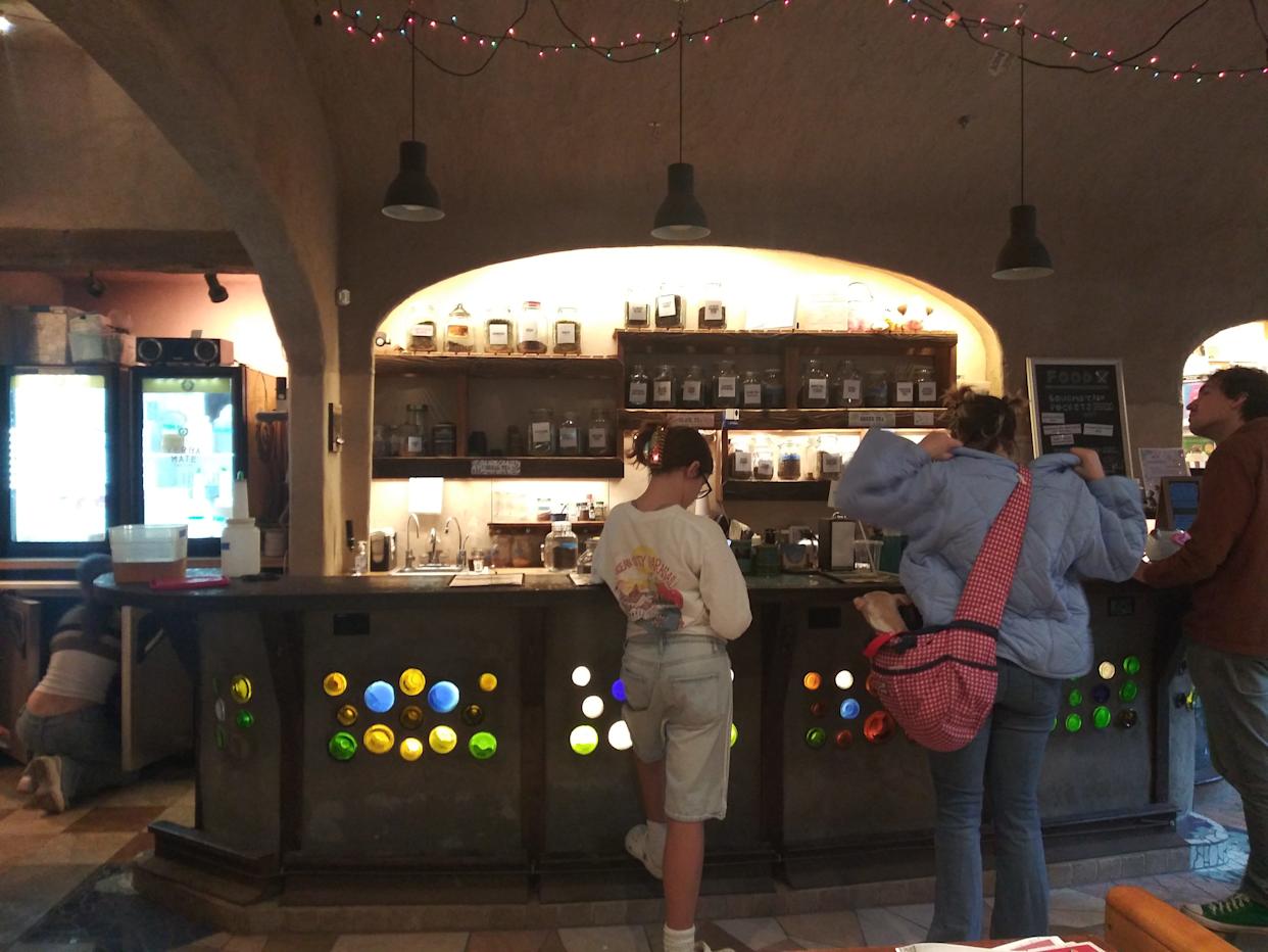 Dimly lit Interior of Bantha Tea, people standing by counter
