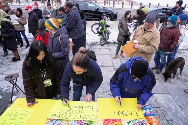 People make signs as demonstrators gather Tuesday to protest removal of explanatory panels. (AP Photo/Matt Rourke)