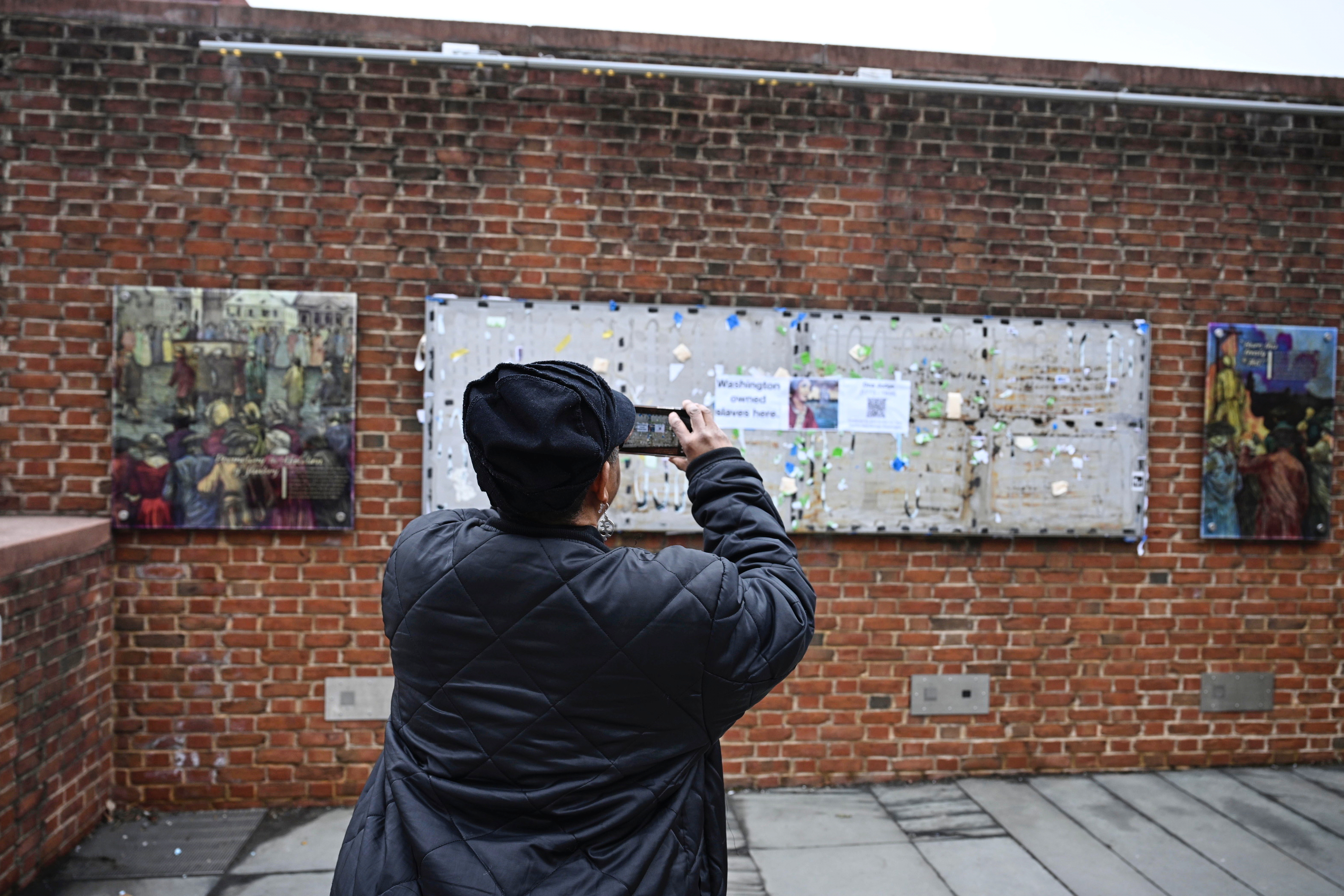 A person takes a photo as panels that were part...