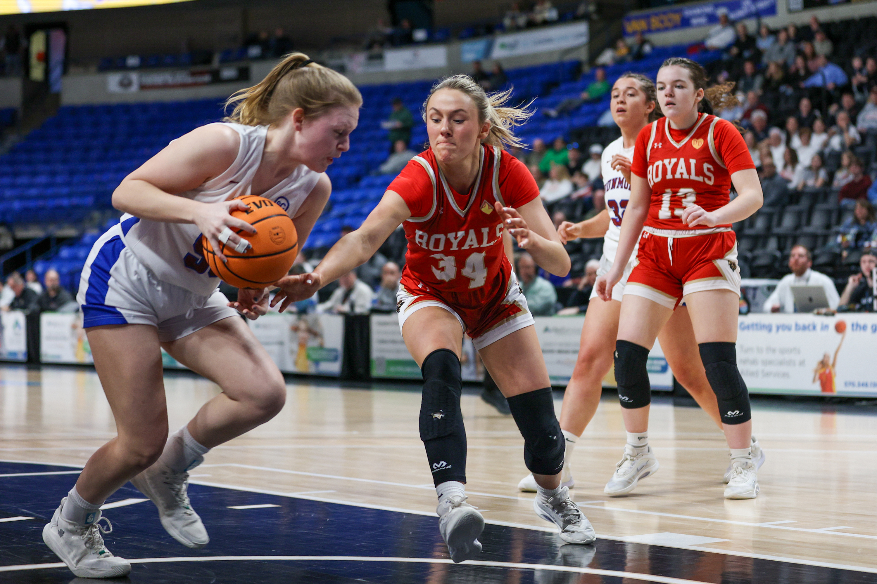 Dunmore’s Jackie Brown (50) grabs a rebound before Holy Redeemer’s...