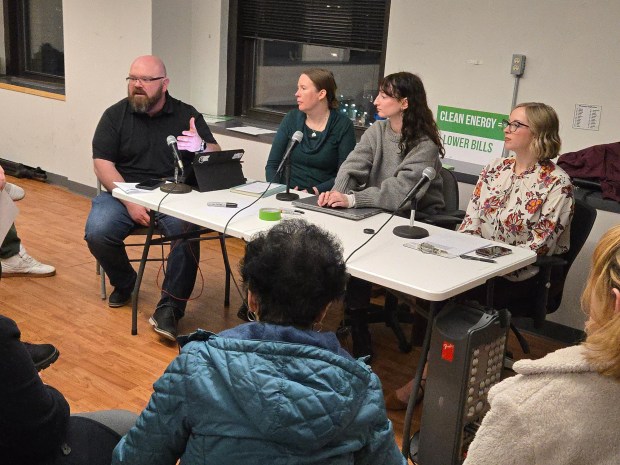 Anthony Gratter, regional organizer for Affordable Pennsylvania, addresses a member of the audience at an energy cost roundtable Tuesday in the Luzerne Bank building in Wilkes-Barre. Listening, from left, are panel members Sarah Corcoran, of the Sierra Club, Annie Regan, of Penn Future, and Joyanna Hopper, a political science professor at the University of Scranton. (STEVE MOCARSKY / STAFF PHOTO)