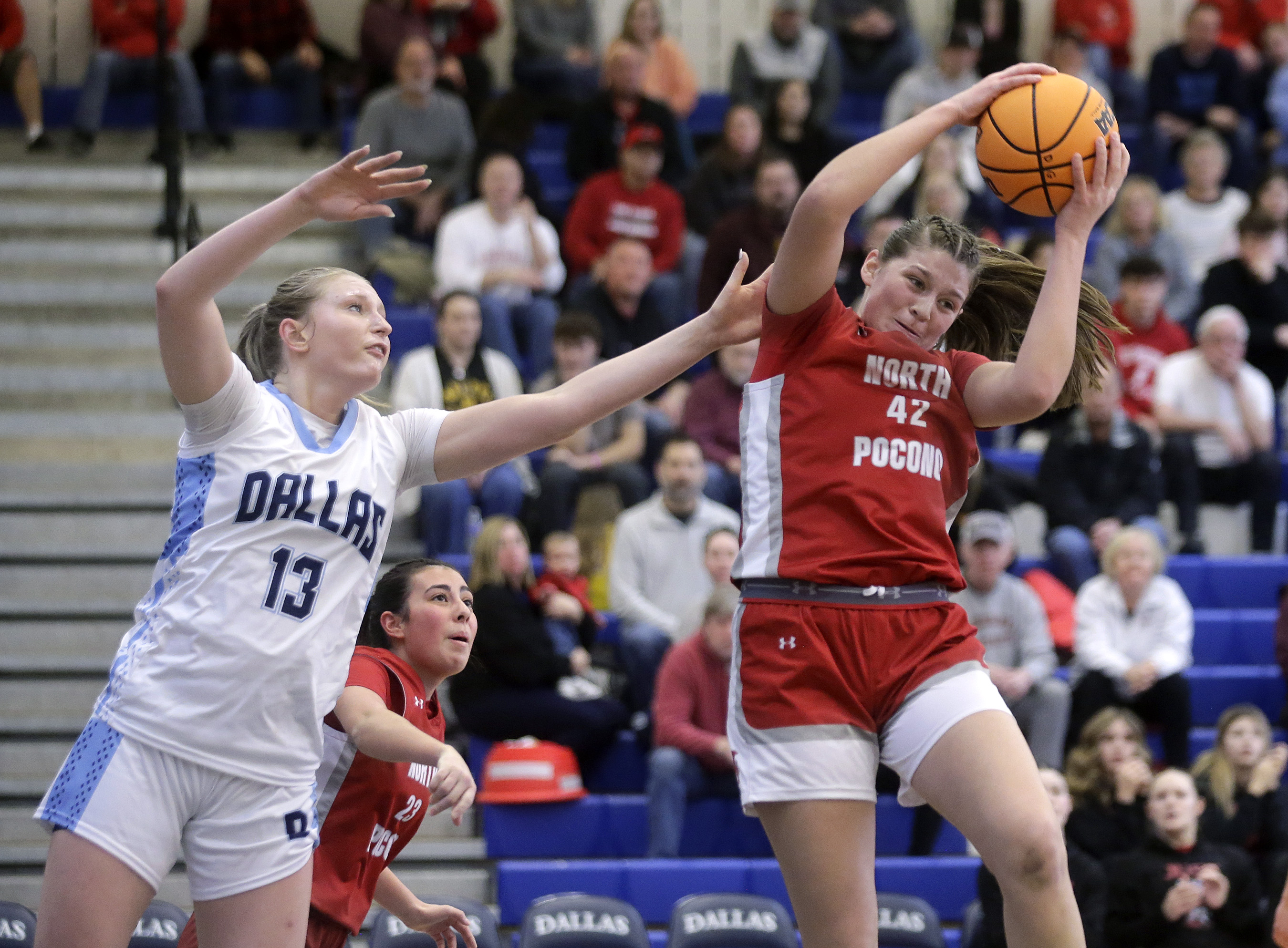 North Pocono’s Anna Clementoni, right, grabs a defensive rebound ahead...