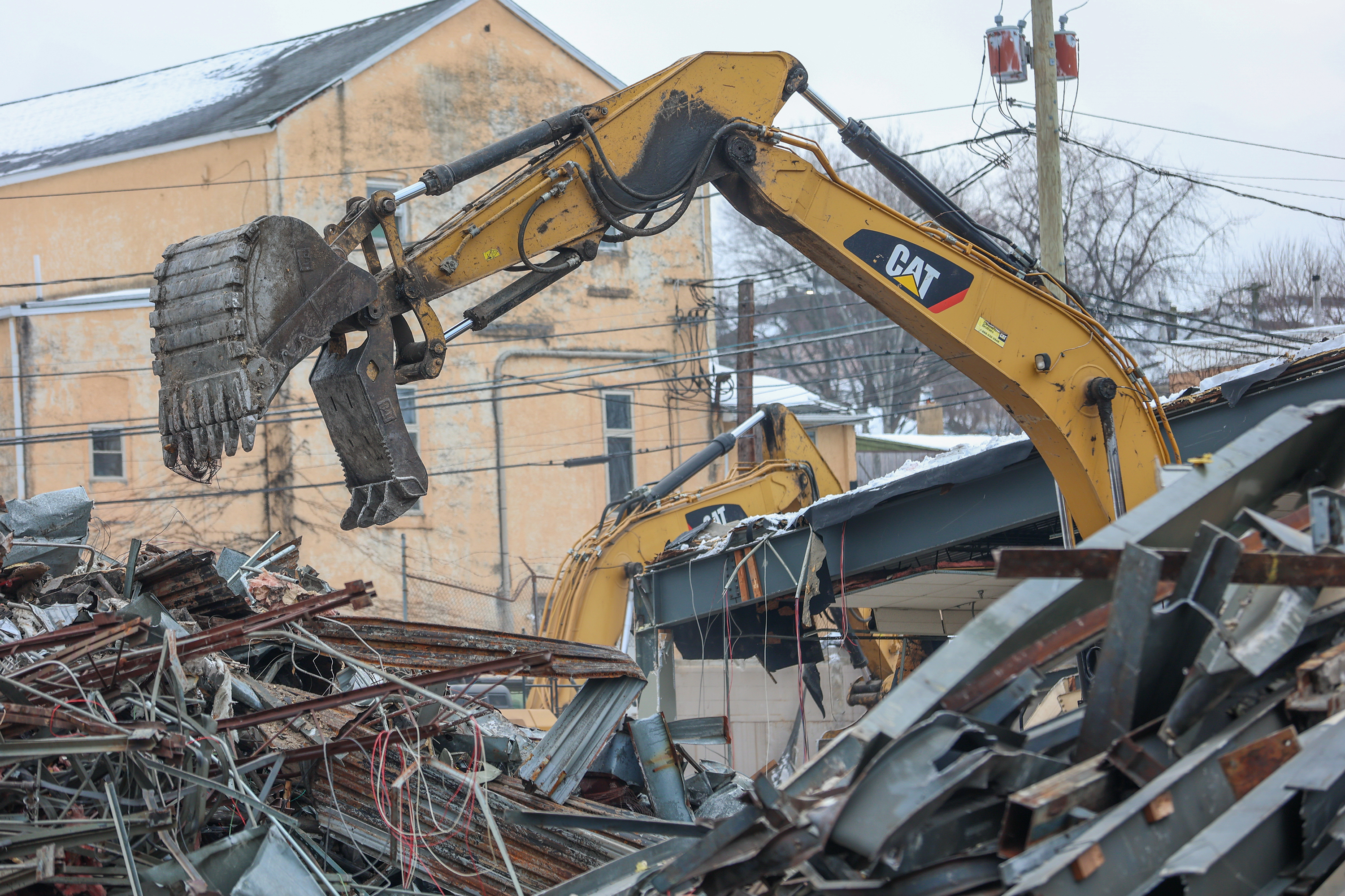 Two cranes demolish the former Quinn’s Supermarket in Pittston on...