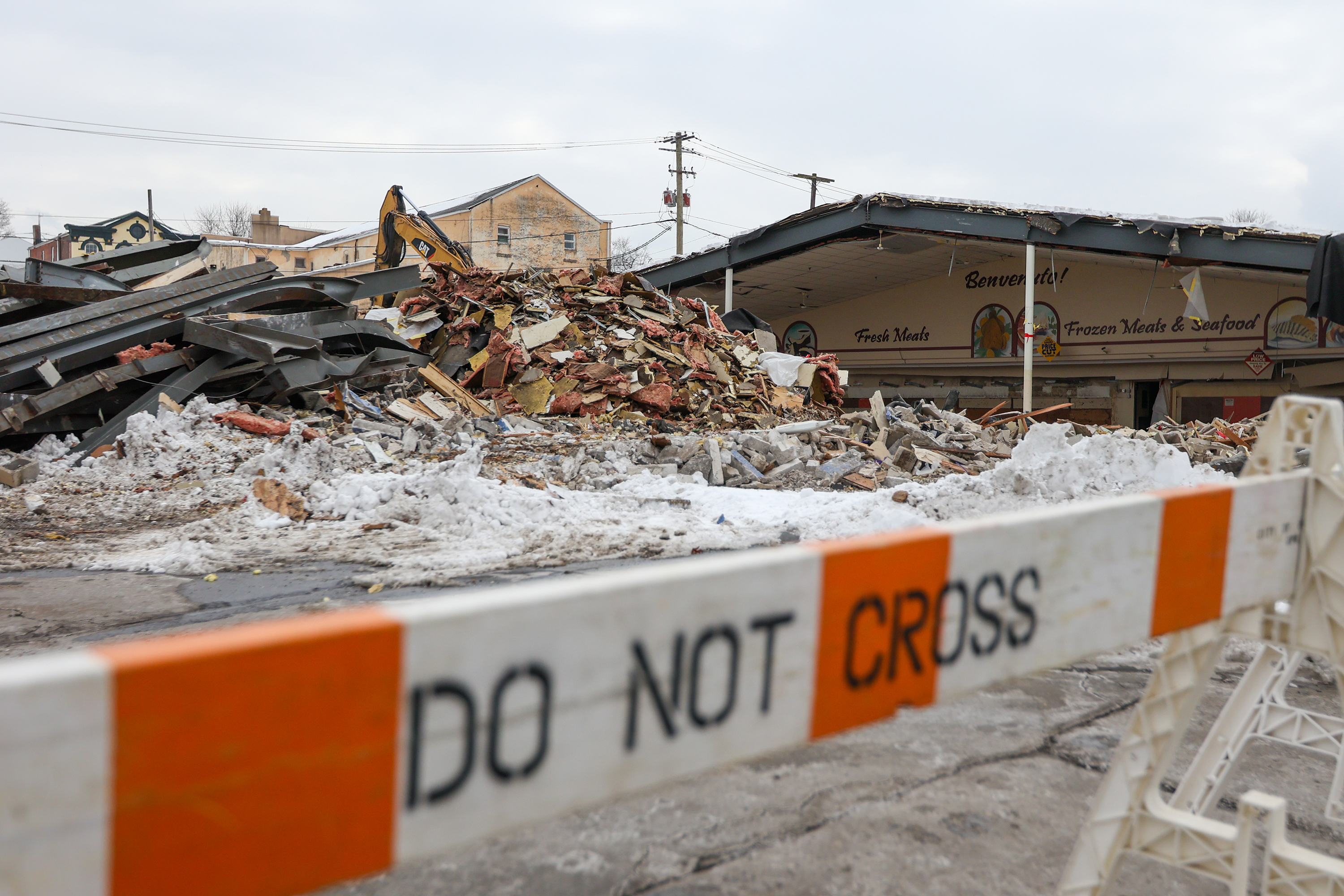 A ‘Do Not Cross’ barrier blocks off a parking lot...