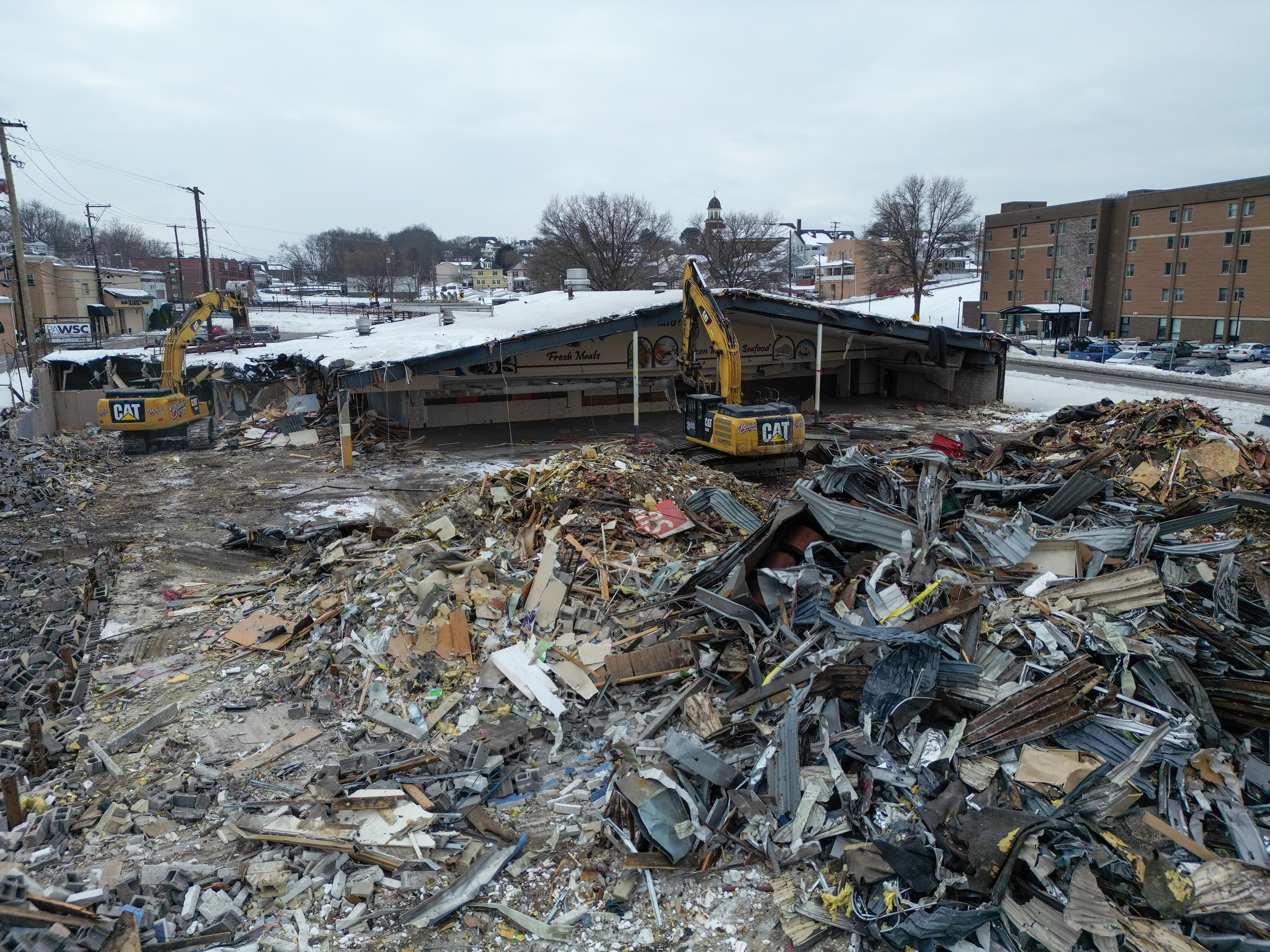 Two cranes demolish the former Quinn’s Supermarket in Pittston on...