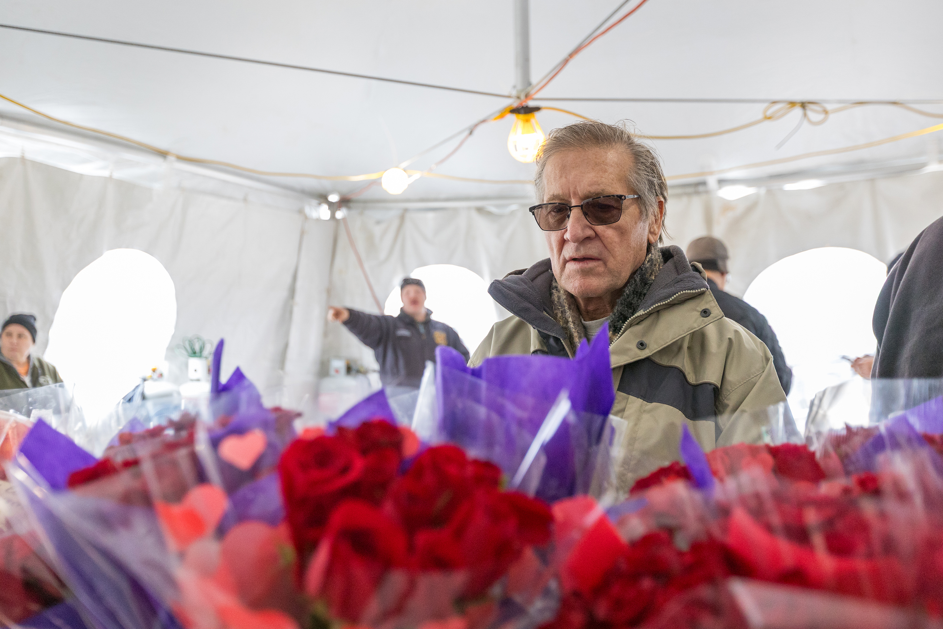 Mike Bestider, of West Pittston, browses bouquets of roses during...