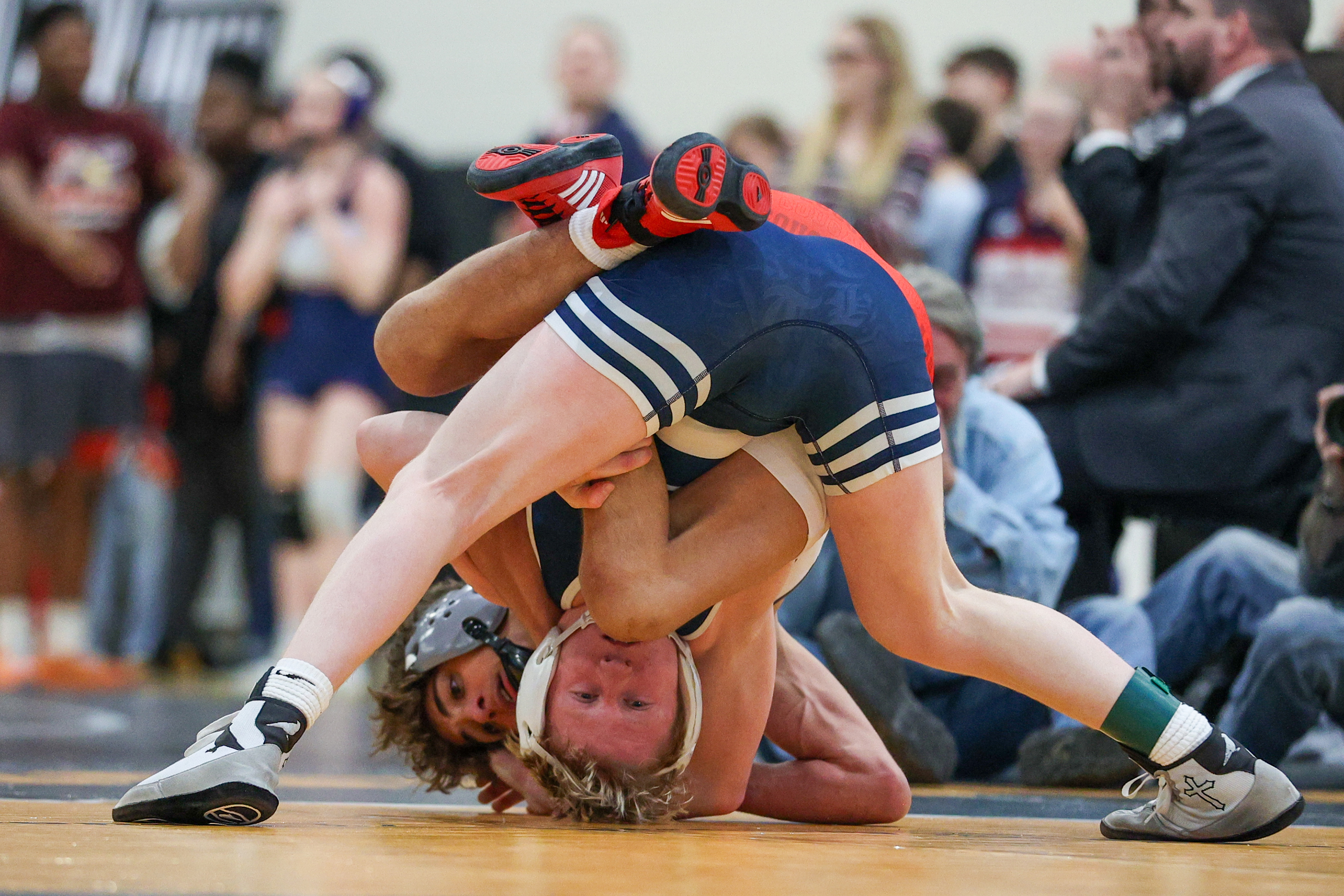 Abington Heights’ Dakota Sandy, front, wrestles Hazleton Area’s Gabe Benyo...