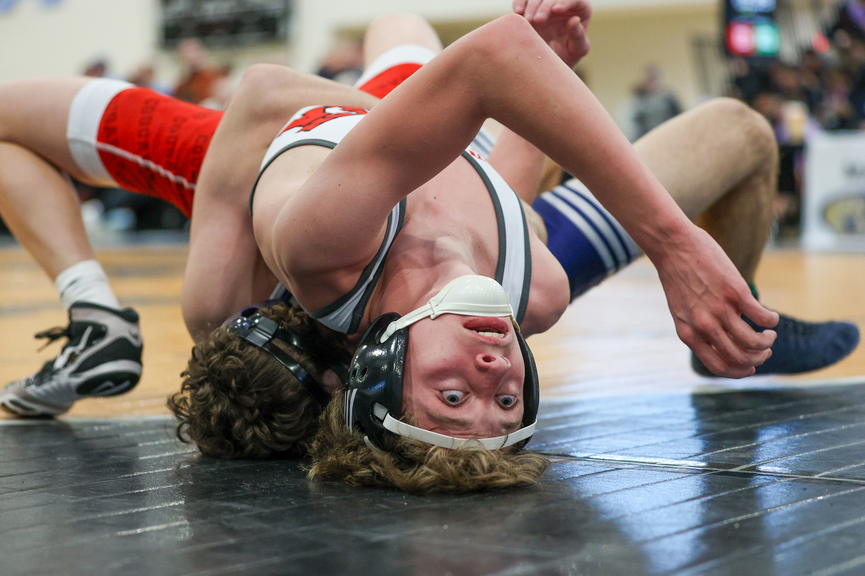 Abington Heights’ Mason Whitney, bottom, wrestles Hazleton Area’s Jude Salko...