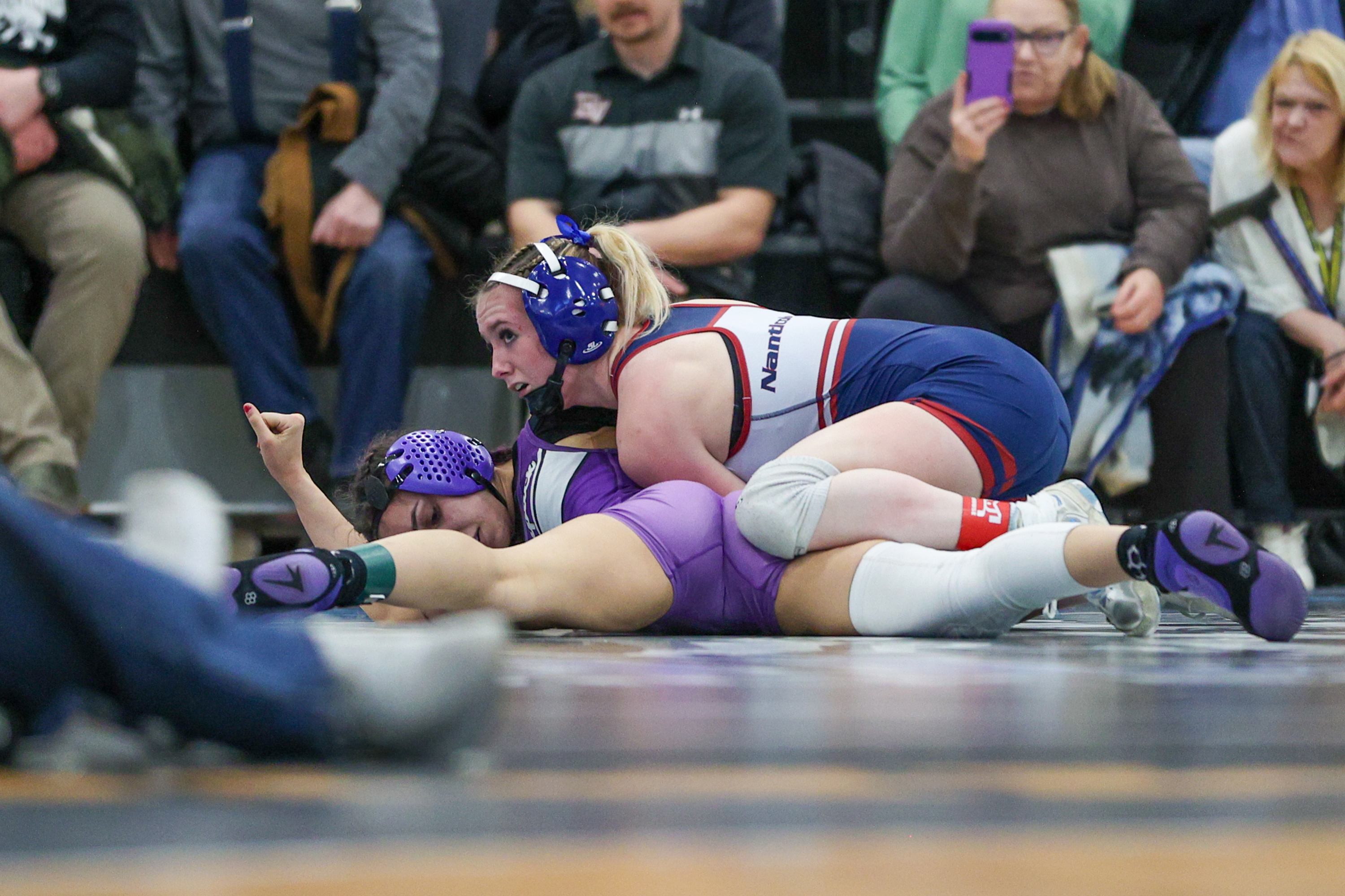Nanticoke’s Emily Kivler holds down Wallenpaupack’s Gia Silva during the...
