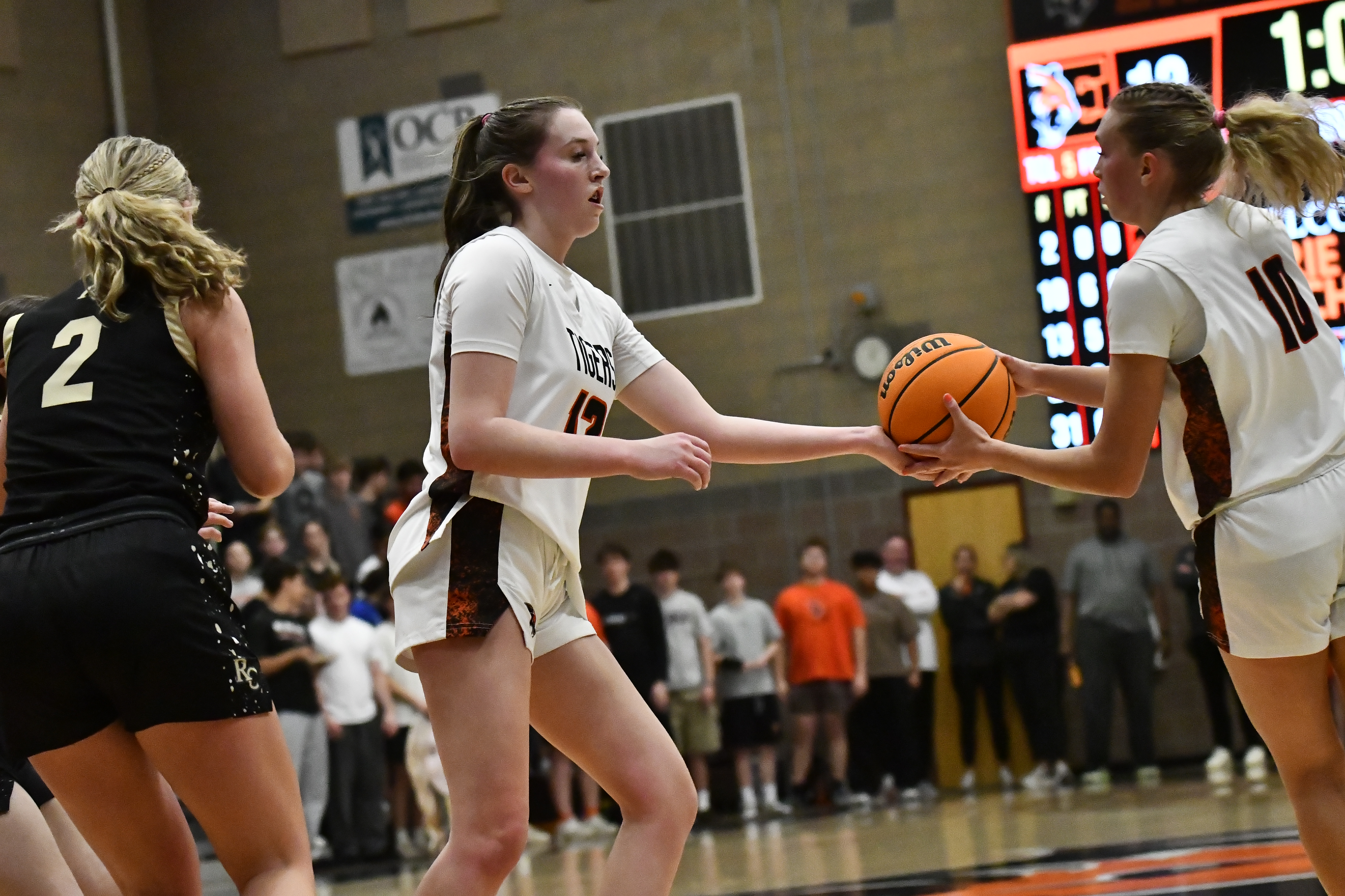 Erie’s Sophie Husk (13) hands the ball off to Juliet...