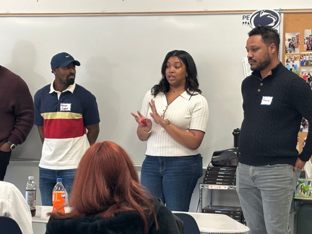 Rajeena Humphrey, center, talks to Academy Park High School students during the What's Your Passion? Local Ideas Festival on Saturday. (KATHLEEN E. CAREY - DAILY TIMES)