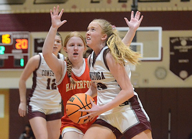 Conestoga's Maggie Neary drives to the basket as Haverford's Grace Maloney defends Tuesday night at Lower Merion. Neary scored 10 points to help the Pioneers claim the Central League championship with a 59-43 victory. (PETE BANNAN/MediaNews Group)