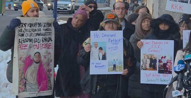 Supporters holding signs for Parady La of Upper Darby, who died last month after being taken into custody by ICE, during a late-day rally Thursday outside the Philadelphia Federal Detention Facility. (ALEX ROSE - DAILY TIMES)