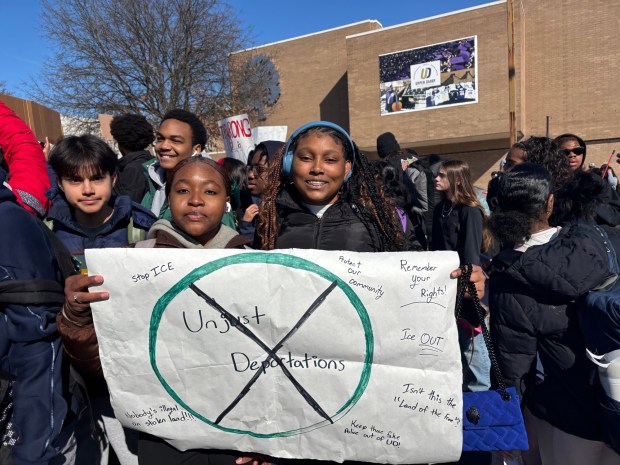 Upper Darby High students Kamiah Braswell, left, and Sanai Reaves hold a homemade sign during the walkout against ICE. (KATHLEEN E. CAREY - DAILY TIMES)