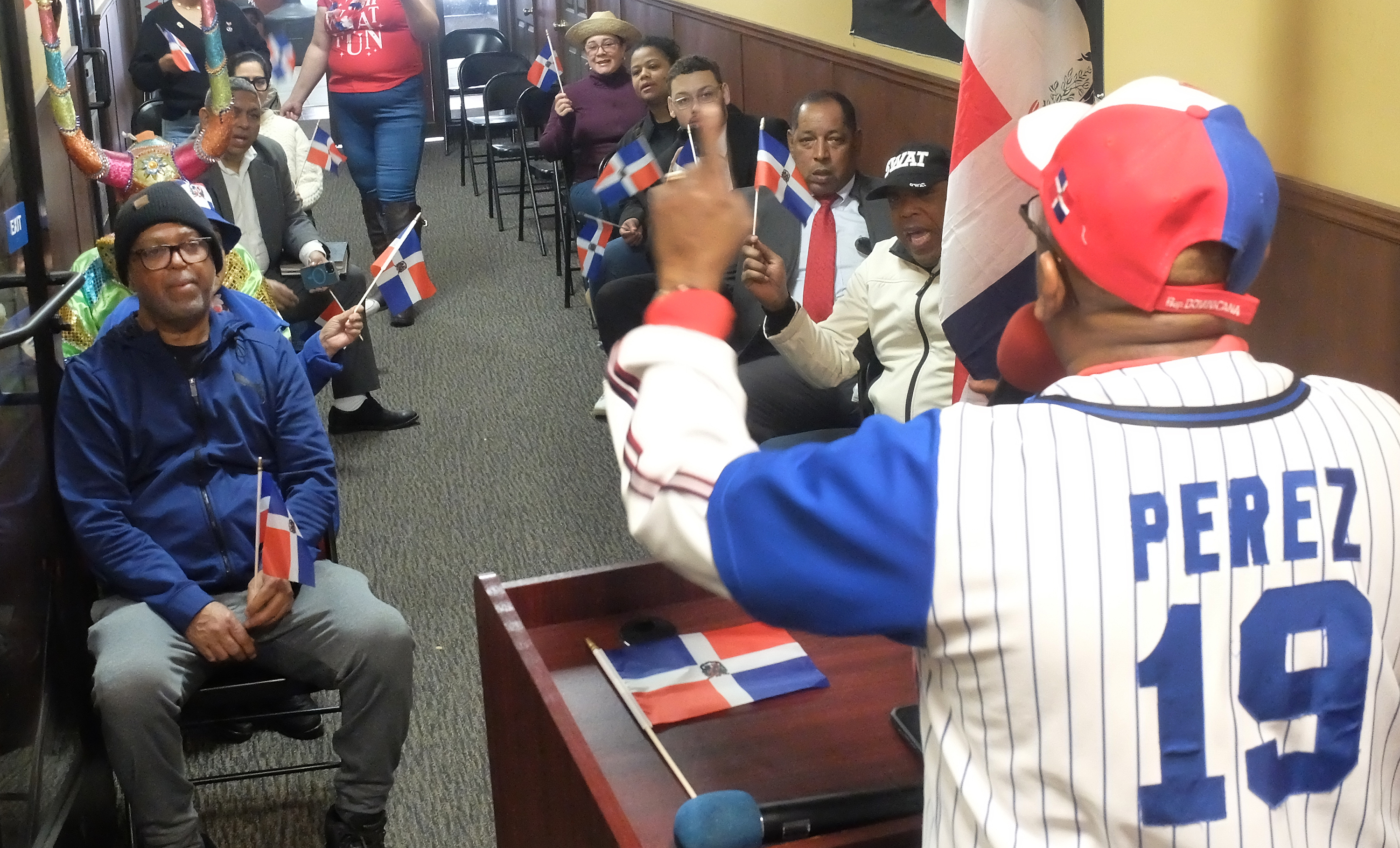 People look on and listen as Victor Perez speaks during...