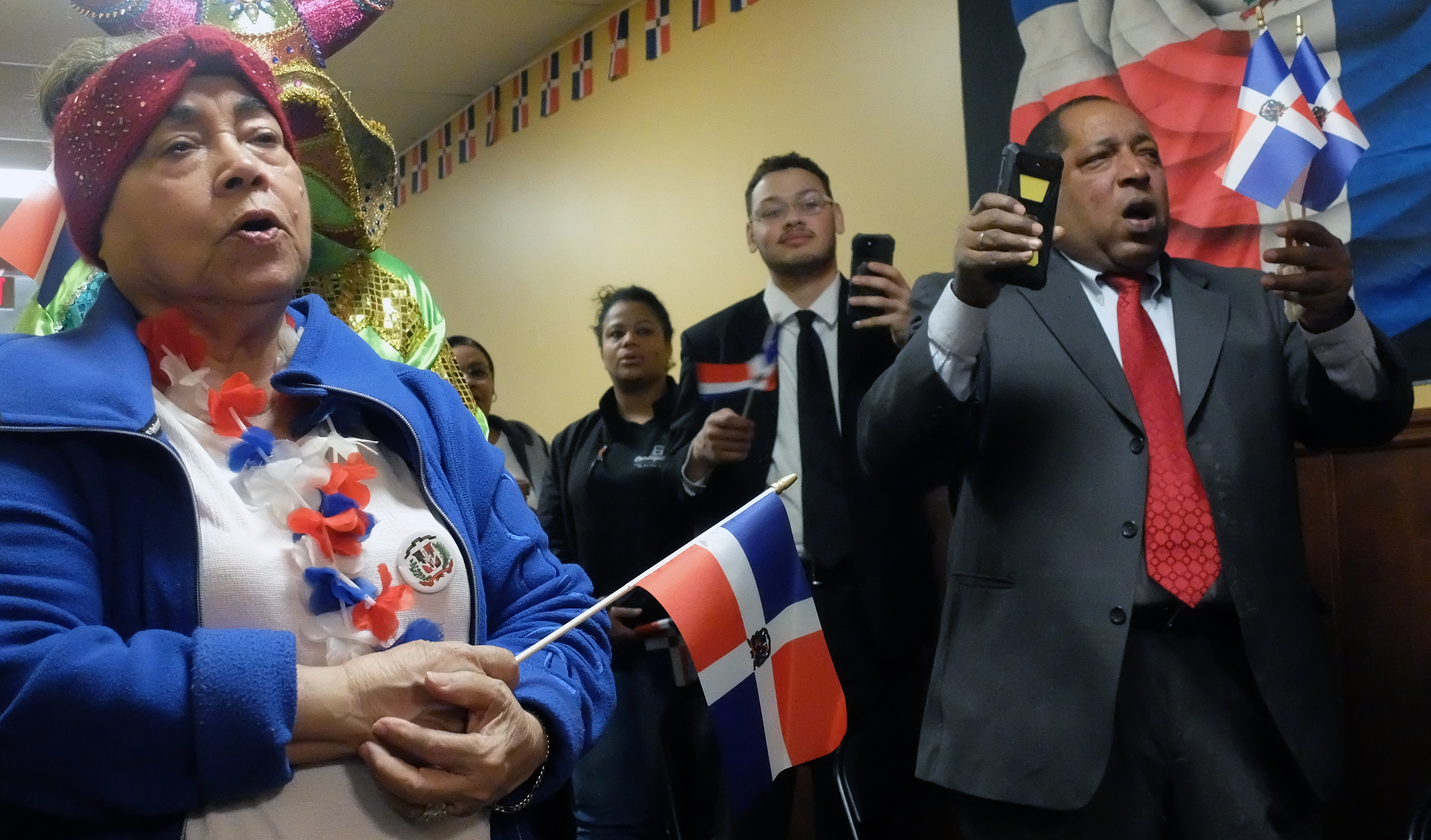 Altagracia Jimenez, left, joins attendees in singing the Dominican Republic...