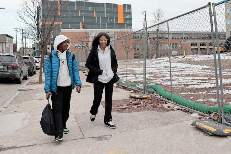 Ninth graders Gabriel Dinkins (left) and Briah Boyd walk home from Paul Robeson High School for Human Services in West Philadelphia.
