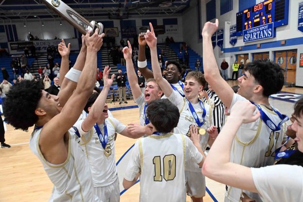The Berks Catholic Saints celebrate their 58-52 overtime District 3 Class 4A victory over Bishop McDevitt on Friday, Feb. 27, 2026, at Garden Spot High School in New Holland. (BILL UHRICH/READING EAGLE)