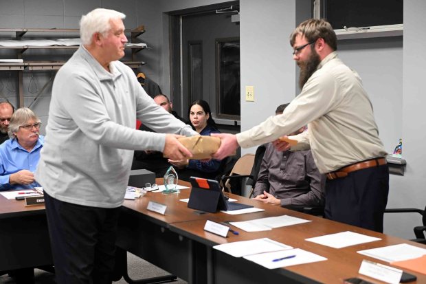 Mount Penn Mayor Ryan Maurer gives retiring Central Berks Police Chief Raymond Serafin a gift during a ceremony at the Mount Penn Borough Hall on Tuesday, Jan. 27, 2026. (BILL UHRICH/READING EAGLE)