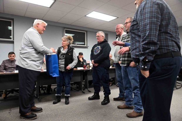 Saint Lawrence Mayor Corrie Crupi-Zana along with Saint Lawrence Borough Council members give retiring Central Berks Police Chief Raymond Serafin a gift during a ceremony at the Mount Penn Borough Hall on Tuesday, Jan. 27, 2026. (BILL UHRICH/READING EAGLE)