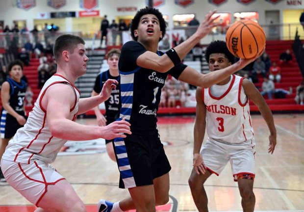 Exeter's Jayden Ware sweeps in a hook shot over Wilson's Michael Glover in a 43-41 Eagles' BCIAA quarterfinal victory over the Bulldogs on Monday, Feb. 9, 2026, at West Lawn. (BILL UHRICH/READING EAGLE)