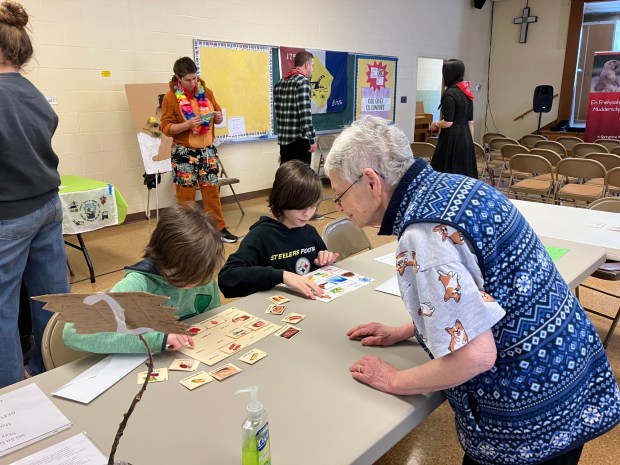 Gryffyn Spayd and Oliver Spayd complete PA German word match games with Jan Heagy at the Pennsylvania German Zammelaaf's Groundhog Lodge for Youth event on Jan. 31. (Photo courtesy of Mary Laub)