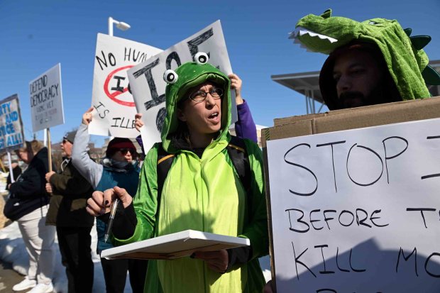 Alyse Rosania collects signatures during a protest against the Immigration and Customs Enforcement purchase of a warehouse in Upper Bern Township for use as a processing facility for detainees. (BILL UHRICH/READING EAGLE)