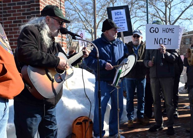 Harry Prutzman of Hamburg sings protest songs during a protest in Wyomissing Saturday against the Immigration and Customs Enforcement purchase of a warehouse in Upper Bern Township for use as a processing facility for detainees. (BILL UHRICH/READING EAGLE)