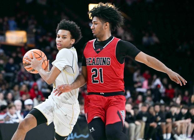 Berks Catholic's Carmelo Harper drives for two of his 14 points against Reading's Weshley Rosario in a 62-57 Saints victory over the Red Knights in the BCIAA boys' final on Friday, Feb. 13, 2026, at the Santander Arena. (BILL UHRICH/READING EAGLE)