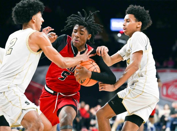 Reading's Jostin DeCastro is fouled as he drives against Berks Catholic in a 62-57 Saints victory over the Red Knights in the BCIAA boys' final on Friday, Feb. 13, 2026, at the Santander Arena. (BILL UHRICH/READING EAGLE)