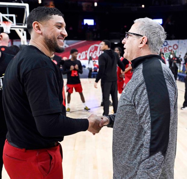 Reading High coach Rick Perez congratulates Berks Catholic coach Snip Esterly following a 62-57 Saints victory over the Red Knights in the BCIAA boys' final on Friday, Feb. 13, 2026, at the Santander Arena. (BILL UHRICH/READING EAGLE)